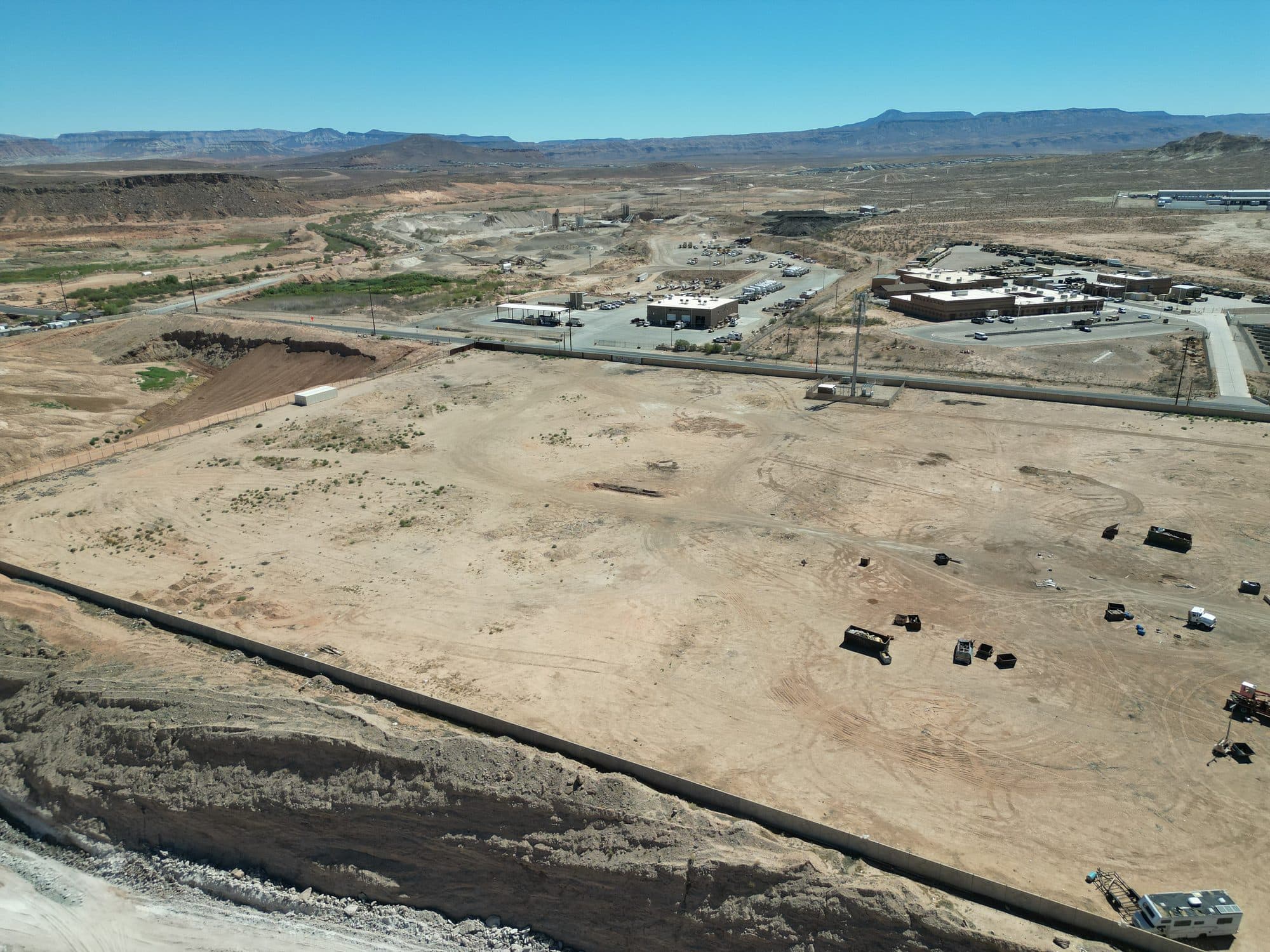 Aerial view of the edge of the parcel with open land and hills in the distance