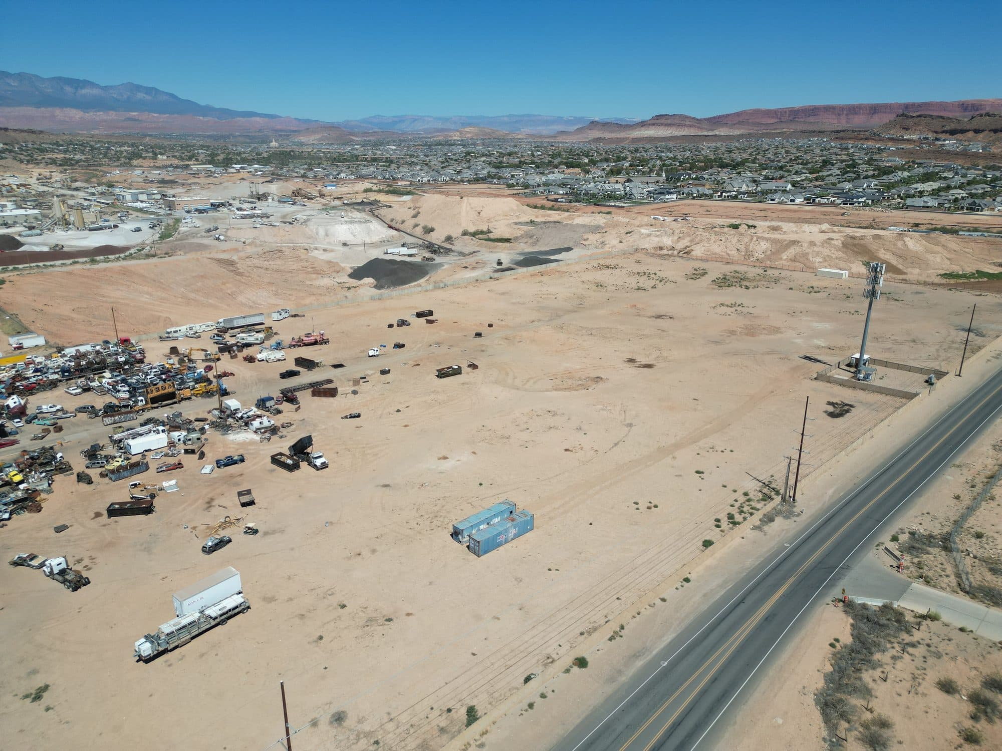 Aerial view of the road alongside the property with the city and red-rock mesas beyond